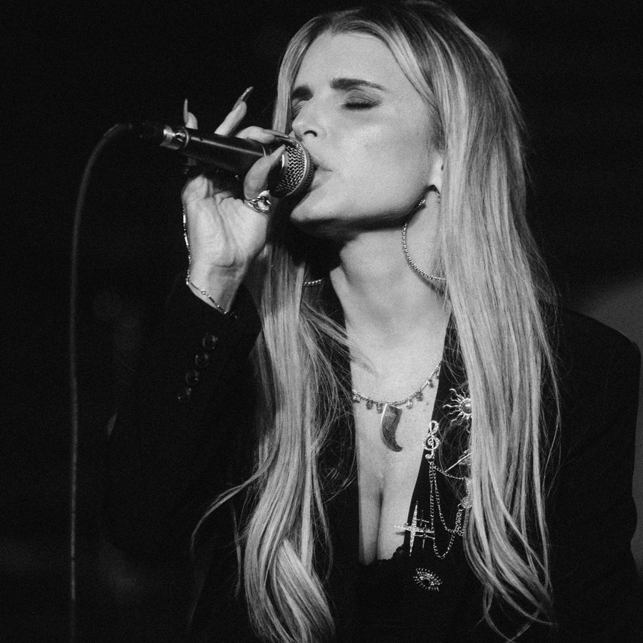 Jessica Simpson singing into microphone