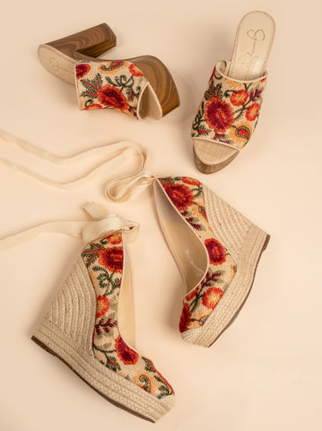 Floral wedge sandals on a beige background