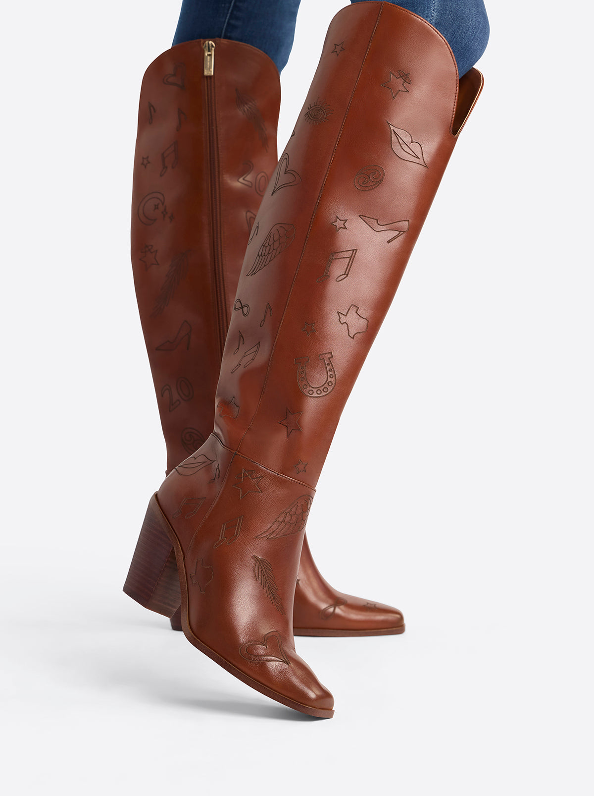 Brown knee-high boots with decorative patterns on a white background