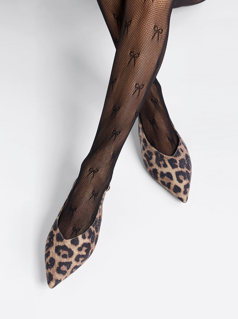 Leopard print shoes with black patterned tights on a white background